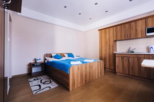 a bedroom with a bed and a sink at Lak6 Apartment in Mórahalom