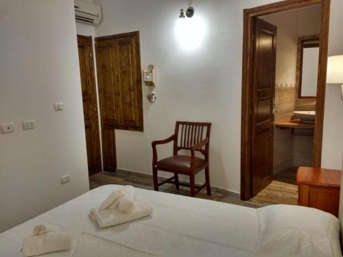 a bedroom with a bed and a chair and a desk at B&B LE ISOLE in San Teodoro