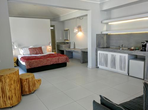 a bedroom with a bed and a sink in it at Loriet Hotel in Mytilene