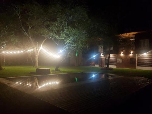 a night time picture of a swimming pool with lights at Piracuacito in Paso de la Patria