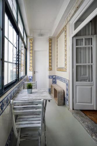 a room with a wooden table and a door at 1924 in Lisbon