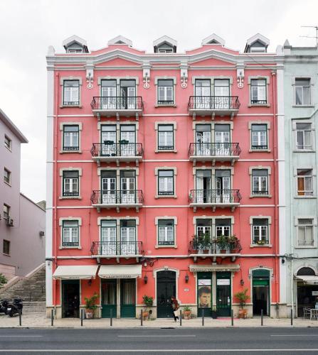 a red building on the side of a street at 1924 in Lisbon