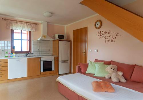 a living room with a couch with a teddy bear on it at PLANINCA -hiša z razgledom in Šmarje pri Jelšah