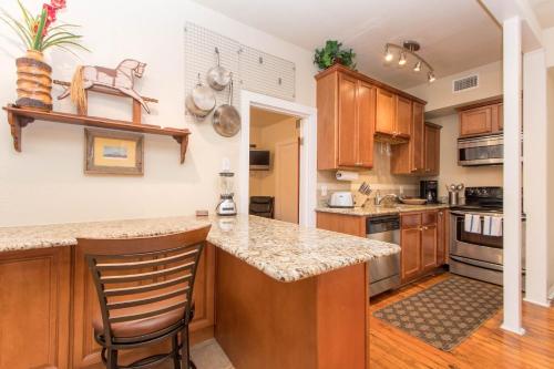 a kitchen with wooden cabinets and a counter top at THE MADISON - San Antonio Riverwalk - Downtown - Convention Center in San Antonio