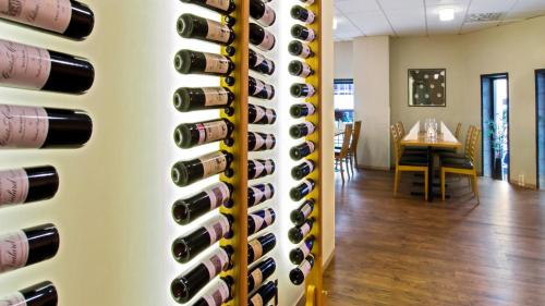 a wall of wine bottles in a dining room at Best Western Plus Grand Hotel Elektra in Ludvika