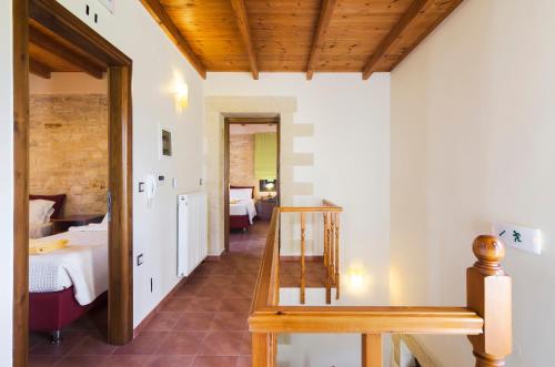 a hallway with a room with a bed and a table at Villas Kalives in Kalyves