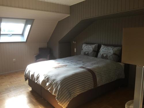a bedroom with a large bed with a window at Haus BuylBergh in Lichtenborn