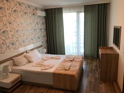Postel nebo postele na pokoji v ubytování OLYMP Aparthotel