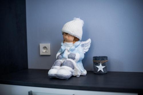 a small figurine of an angel sitting on a counter at Golf apartment with SPA tickets discount in Moravske Toplice