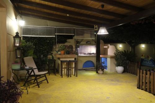 a patio with chairs and a table and a stove at Rafina great feeling villa in Rafina