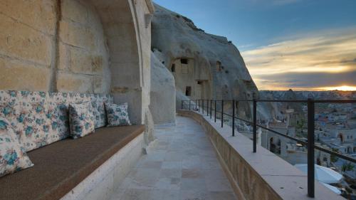 a balcony with benches on the side of a building at Vezir Cave Suites in Goreme