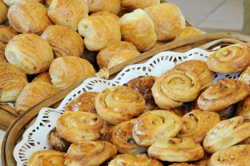a bunch of pastries in baskets on a table at Country Lodge Hotel & Resort Beirut in Beirut
