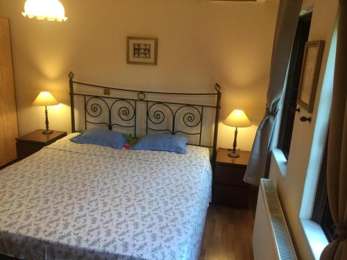 a bedroom with a white bed with two lamps at Rafina great feeling villa in Rafina
