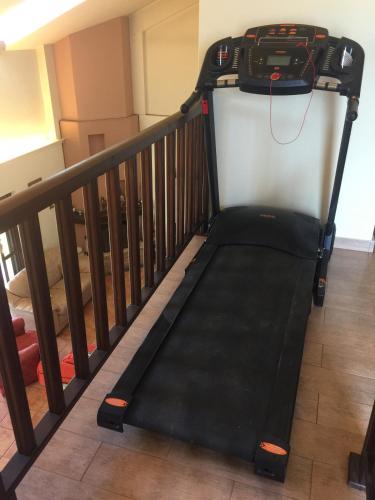 a treadmill is sitting on a stair railing at Rafina great feeling villa in Rafina
