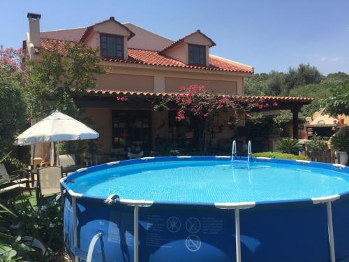a swimming pool in front of a house at Rafina great feeling villa in Rafina