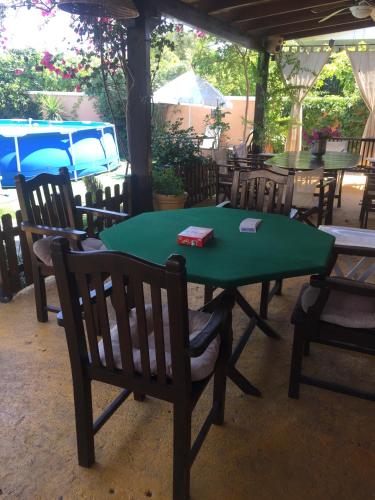a green table and chairs in a restaurant at Rafina great feeling villa in Rafina