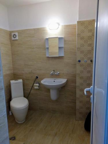 a bathroom with a toilet and a sink at Aura in Primorsko
