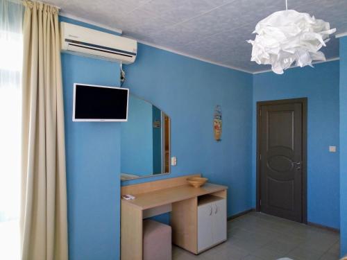 a blue bathroom with a sink and a mirror at Aura in Primorsko