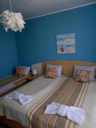 a bedroom with two beds with towels on them at Aura in Primorsko