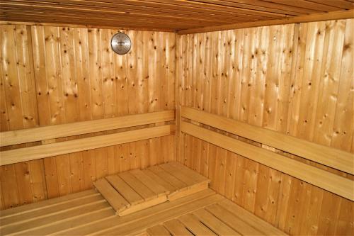 a wooden sauna with a bench in it at Penzion Sumavacek in Bayerisch Eisenstein