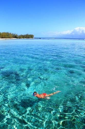 a person laying in the water in the ocean at Chez Cozy's in Albion