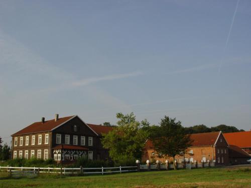 a group of buildings in a field with a fence at Bleckmanns Hof in Werne an der Lippe