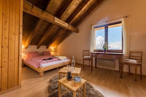 a bedroom with a bed and a desk in a room at Berghotel Chäserstatt in Ernen