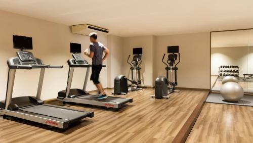 a man running on a treadmill in a gym at Izu Marriott Hotel Shuzenji in Izu