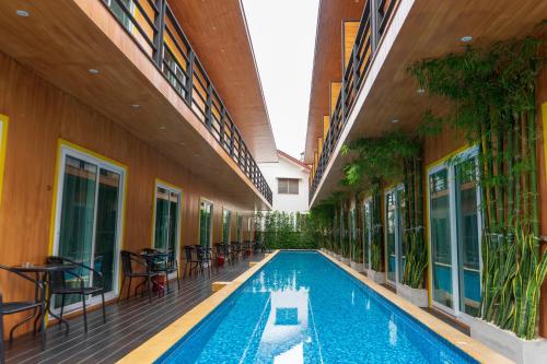 a swimming pool in the middle of a building at Resort V - MRT Huai Khwang in Bangkok