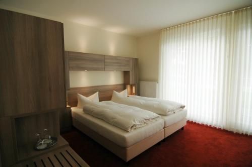 a bedroom with a large bed with a large window at Altes Landhaus in Lingen