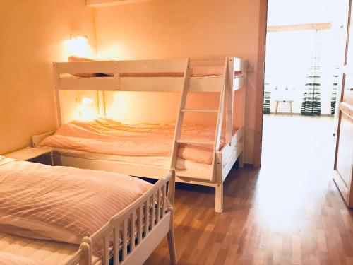 a bedroom with two bunk beds and a bed at Villa Holmen, ground floor apartment in Balestrand