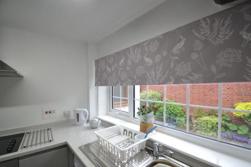 a kitchen with a sink and a window at Abbey Cottage in Shrewsbury