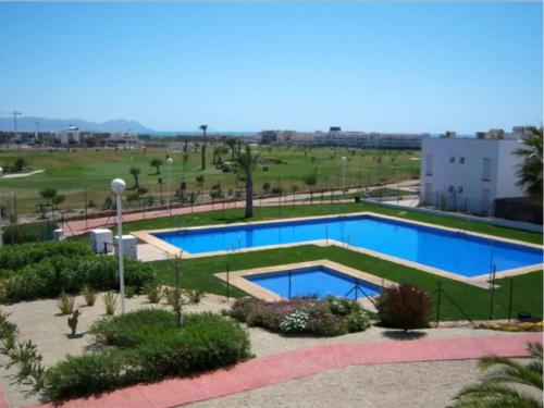 a swimming pool in a resort with a golf course at Apartamento Recién reformado en EL TOYO in Retamar