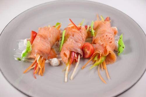 a plate of food with salmon and vegetables on it at Mediteran Hotel & Resort in Budva