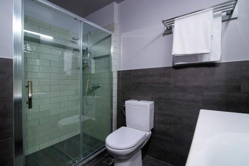a bathroom with a toilet and a glass shower at Urban Donkey in Thessaloniki