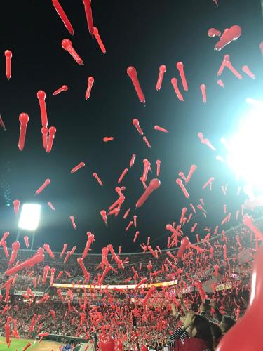 a crowd at a baseball game with red balloons in the air at Hotel Jupiter (Adult Only) in Hiroshima