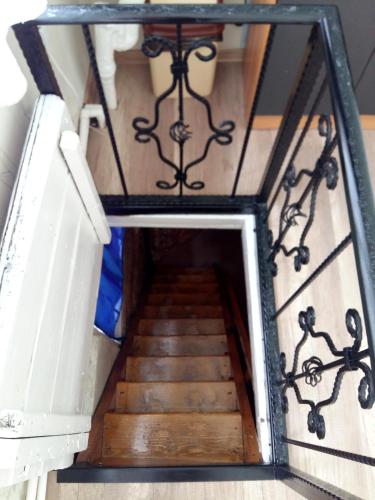 a stairway with wooden steps in a building at Gulo's Home in Tbilisi City