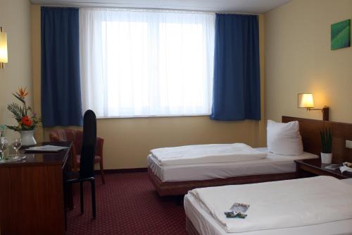 Ένα ή περισσότερα κρεβάτια σε δωμάτιο στο Quick Hotel Dresden West