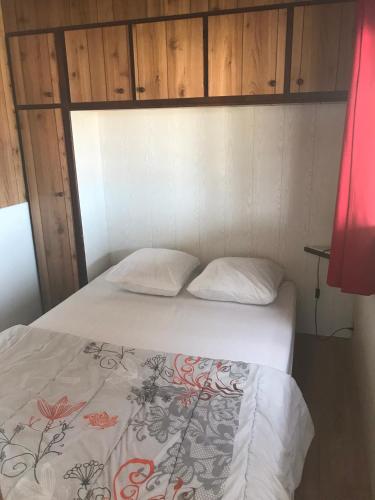 a bed with two pillows in a room at Camping Trinité in Bonifacio