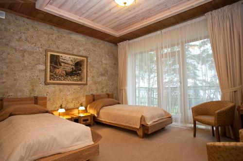 En eller flere senger på et rom på Vila Dubgiris
