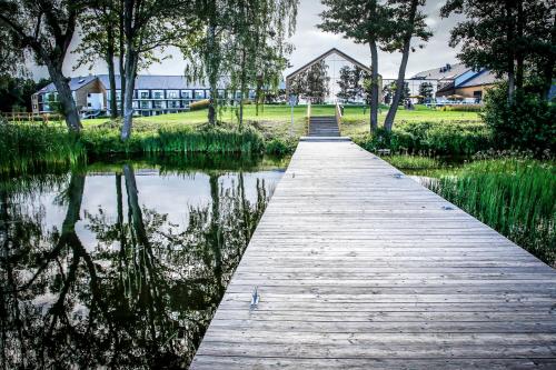 a wooden bridge over a body of water at Hotel Marina Club in Olsztyn