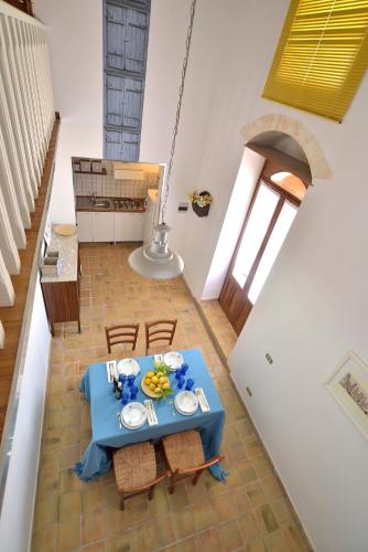a blue table with chairs in a room with stairs at Villa Giannina in Ispica