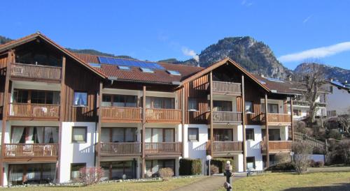 a large apartment building with solar panels on its roof at Ferienwohnung Niklas inklusive Bad Hindelang Plus in Bad Hindelang