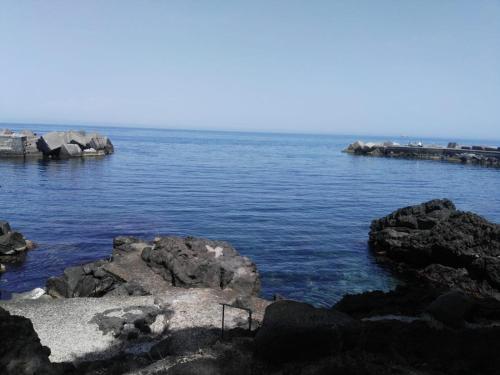 a large body of water with rocks in it at A casa di Edo in Acireale