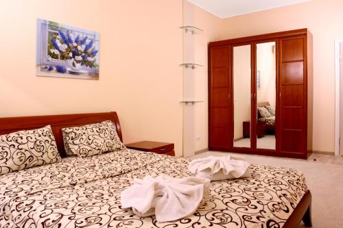 a bedroom with a bed and a mirror at Lukyanovsky in Kyiv