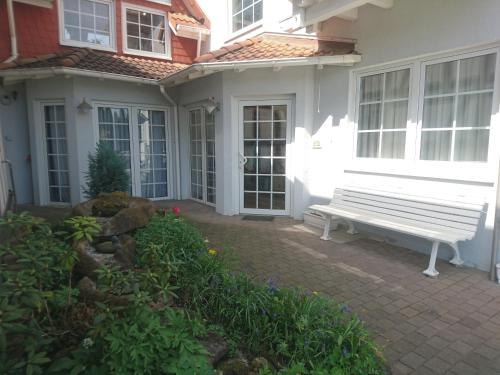 a white bench sitting outside of a house at Landhaus Studio in D 63667 Nidda, Gäßchen 8 Erdgeschoss links in Nidda