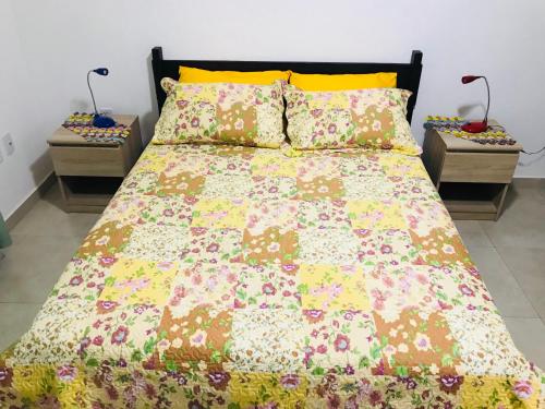 a bed in a bedroom with two night stands at Apartamento em Lencois - Bahia No 106 in Lençóis