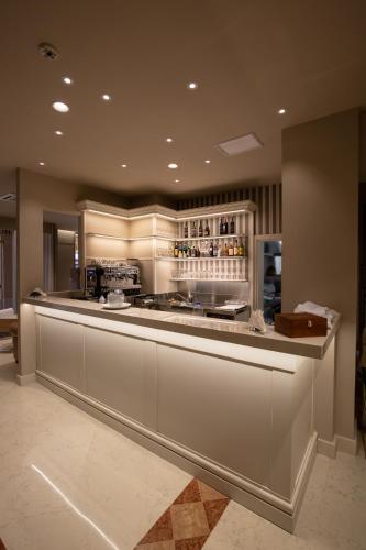 a large kitchen with a counter with a bar at Zanhotel Regina in Bologna