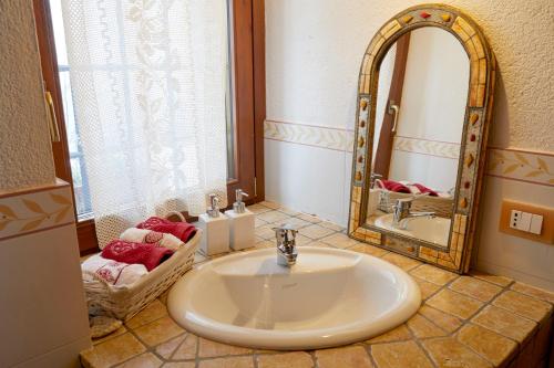 a bathroom with a sink and a mirror at La Terrasse d'Ozein in Ozein