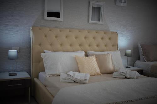 a bedroom with a large bed with white pillows at Central Apartments in Crotone
